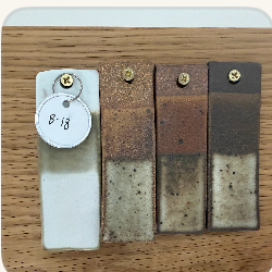 A speckled blue glaze test tile
